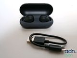 an image of a pair of ear buds sitting on top of a charging case
