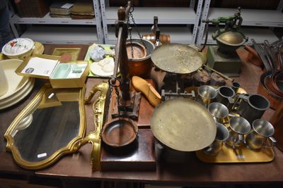 a wooden table with a lot of dishes and pans on it