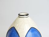a blue and white vase sitting on a table