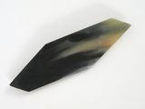a picture of a black and green stone object on a white surface