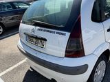 a small white car parked in a parking lot