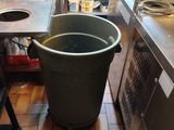 a trash can in the middle of the kitchen