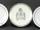 three plates with blue and white designs on them on a black surface