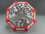 a red and white umbrella with a dog design on it