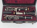 two clarinets in a case on a white surface