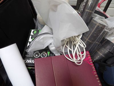 a pile of luggage and other items in the back of a car