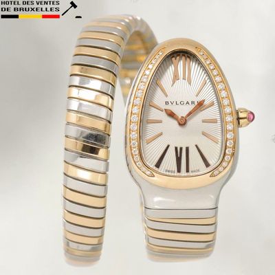 an image of a woman ' s watch and a bracelet on a white surface