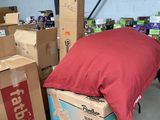 a pile of boxes and a pillow on the floor