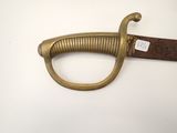 an old sword with a wooden handle on a white surface