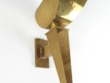 a close up of a brass sconce on a white wall