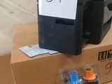 a printer sitting on top of a box with a price tag