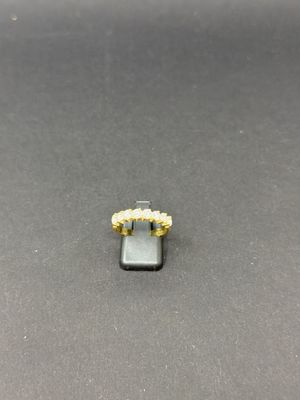 a close up of a gold ring on a black surface