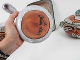 a person holding a bowl with a spoon in front of it