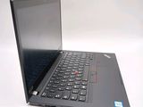 a laptop with a black keyboard sitting on a white surface