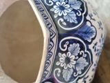 a blue and white vase sitting on a table