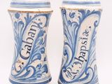 pair of blue and white salt and pepper shakers on a white background