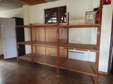 shelves in a room with a refrigerator and a refrigerator freezer