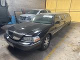 a black lincoln town car parked in a parking lot