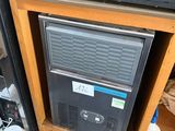 an image of a microwave sitting on top of a wooden cabinet