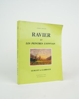 a yellow book with a picture of a river in the background