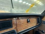 a dashboard of a car with a wooden panel on it