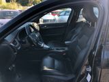 the interior of a car with the door open and the driver ' s seat down