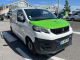 a green and white van parked in a parking lot