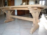 a large wooden table in the middle of a living room
