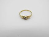 a gold ring with a blue stone in the center