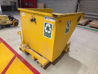a yellow dumpster sitting in the middle of a parking lot