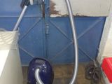 an image of a room with a vacuum and a trash can
