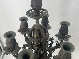 a metal candelab with a bunch of vases on it