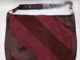 the purse is made of leather and has a brown and red stripe pattern