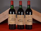 three bottles of red wine sitting next to each other on a table
