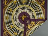 a purple and yellow scarf with a circular design on it