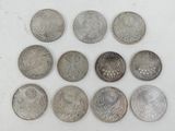 six different types of coins on a white surface