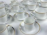 a lot of cups and saucers sitting on a table
