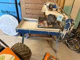 a small table with a saw on it in a garage