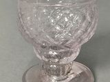 a clear glass cup sitting on top of a saucer