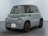 an image of a small electric car in a white room