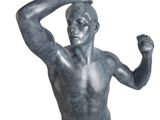 a statue of a man with his arm raised