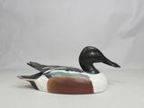 an image of a wooden duck sitting on top of a white surface
