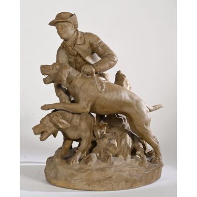 statue of a man riding a horse with two dogs on it