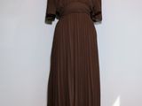 a brown dress on a mannequin stand