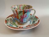 a tea cup and saucer on a white table