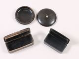 three small black boxes sitting on top of a white surface