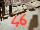 a number 46 painted on the floor next to a pallet
