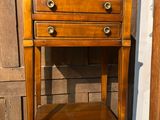 a wooden table with two drawers and a shelf on top of it