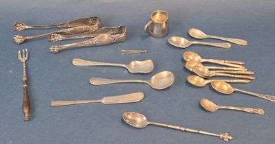 many silver spoons and forks on a blue surface