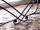 an image of a table with a glass top on a rug